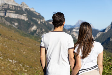 couple in love on excursion. They are looking at the mountains