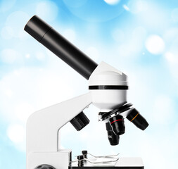 Modern microscope on color background