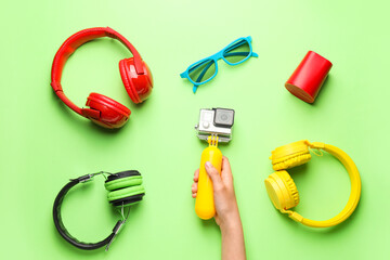 Female hand with different modern devices on color background