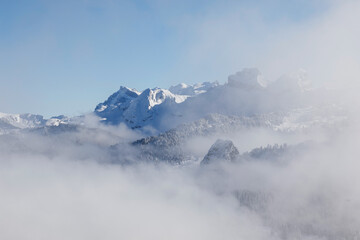 Fototapeta na wymiar Rising fog with the Alps in the background in Central Switzerland