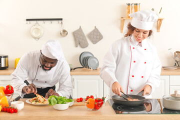 African-American chefs cooking in kitchen