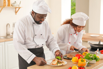 African-American chefs cooking in kitchen