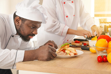 African-American chefs cooking in kitchen