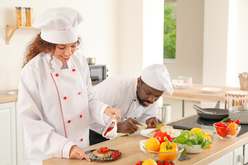 African-American chefs cooking in kitchen