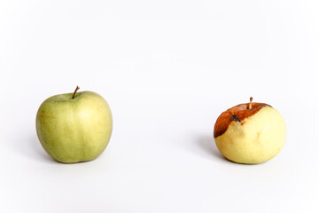 Rotten and fresh apple on white background