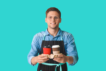 Young male barista on color background