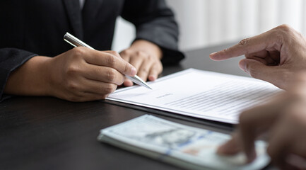 Male employees give bribes to women to sign a contract illegally.