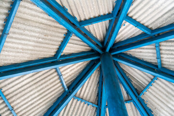 Fototapeta na wymiar Blue metal roof structure with roof tile on top.