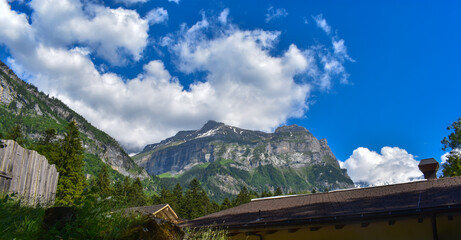 Mountains in the Swiss Alps. Kandersteg mountain range, Switzerland. Blue sky, green trees, sunny weather, summer.