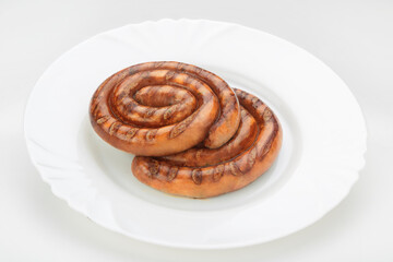 Obraz na płótnie Canvas homemade sausage on a white plate white background