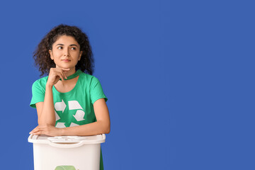 Woman dressed as eco superhero with trash bin on color background