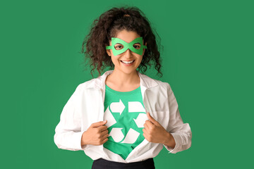 Woman dressed as eco superhero on color background