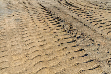 Impints of the truck tires on sand near quarry. Earthworks, offroad