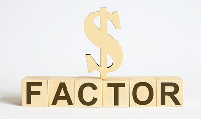 Text FACTOR on wood cube block, stock investment concept.