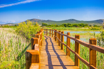 Fototapeta na wymiar Beautiful nature park Vrana lake (Vransko jezero), Dalmatia, Croatia, wooden path in observation park 