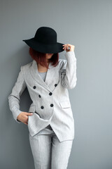 Beautiful fashion woman. Full length portrait of beautiful girl wearing light gray suit and black...