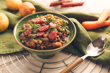 Bowl of tasty lentils soup on table