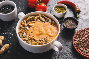Pot of tasty lentils soup on dark background