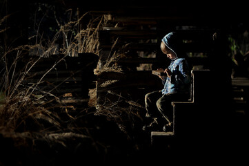 A little boy in his hideout. Secret place, children's secret.