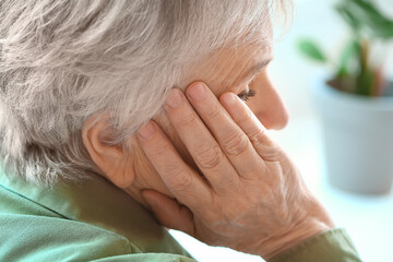 Fototapeta premium Senior woman suffering from headache at home