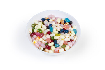 Varicolored jelly beans in bowl on a white background
