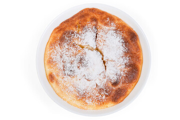 Top view of baked curd souffle sprinkled with sugar powder