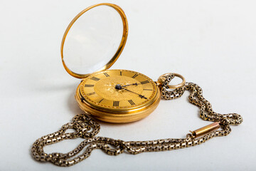 old gold pocket watch on white