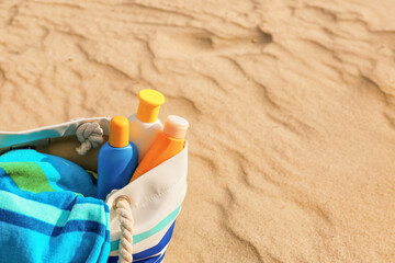 Bag with sunscreen cream on beach