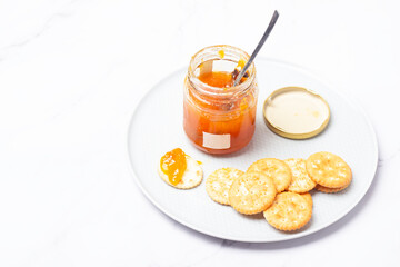 apricot jam and crackers and place for text.