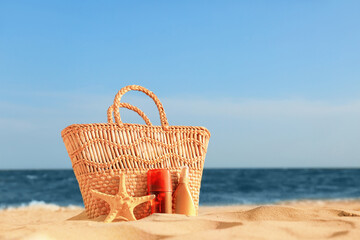 Bag with sunscreen cream on beach