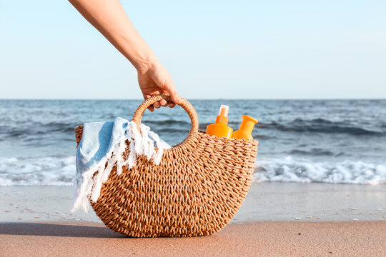Woman With Sunscreen Cream In Bag On Beach
