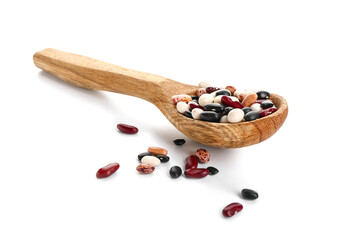 Spoon with raw beans on white background