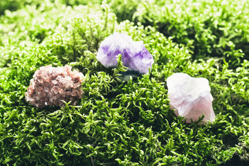Crystal minerals stones on beautiful moss background. Magic stones for rituals, meditation and...