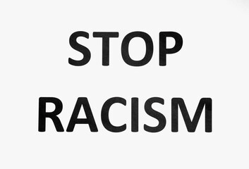 Text STOP RACISM on paper