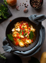Vegetable soup with cauliflower, laurel and other vegetables in cooking pot