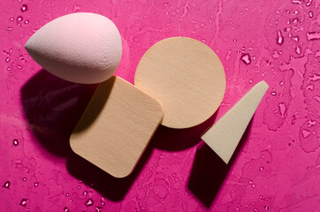 Closeup of beauty sponges on the bright surface, hard shadows