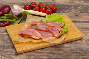 Sliced smoked duck breast served salad