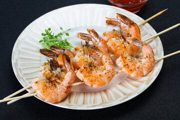 Grilled prawn skewer with sauce