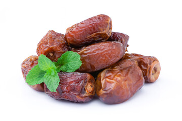 Closeup pile of dried dates palm fruits with mint green leaf isolated on white background. Top view.