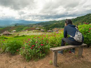 Fototapeta na wymiar A woman sitting and watching the rice terraces.