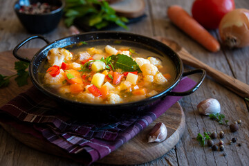 Vegetable soup with cauliflower, laurel and other vegetables