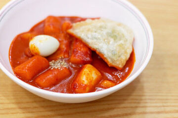Topokki and gravy on a the table view from the side