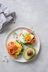 Scrambled eggs with smoked salmon and avocado on toast , Breakfast food