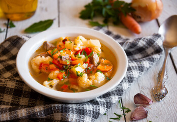 Vegetable soup with cauliflower, laurel and other vegetables