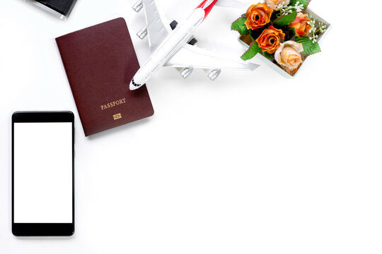 Mockup image of mobile smart phone with blank white screen, passport, camera and airplane model isolated on white background. Technology and Travel concept.  Clipping path.