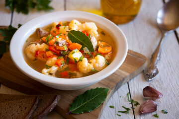 Vegetable soup with cauliflower, laurel and other vegetables
