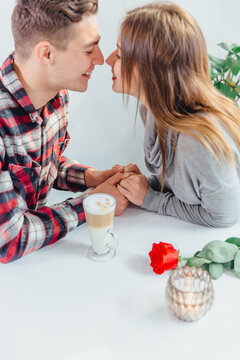 Lovely cropped shot of affectionale boy and girl, holding hands, ready to their first kiss.