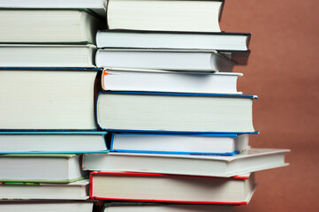 a stack of thick vintage books on a brown background