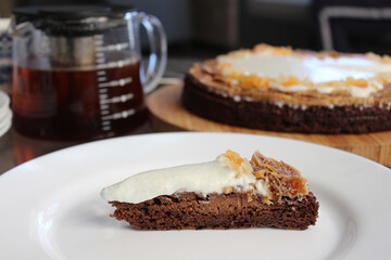 A slice of homemade delicious brownie with cream and dried fruit dates and cantaloupe