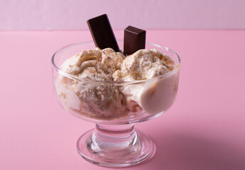 delicious creamy milky vanilla ice cream with caramel and chocolate addings in a glass container 